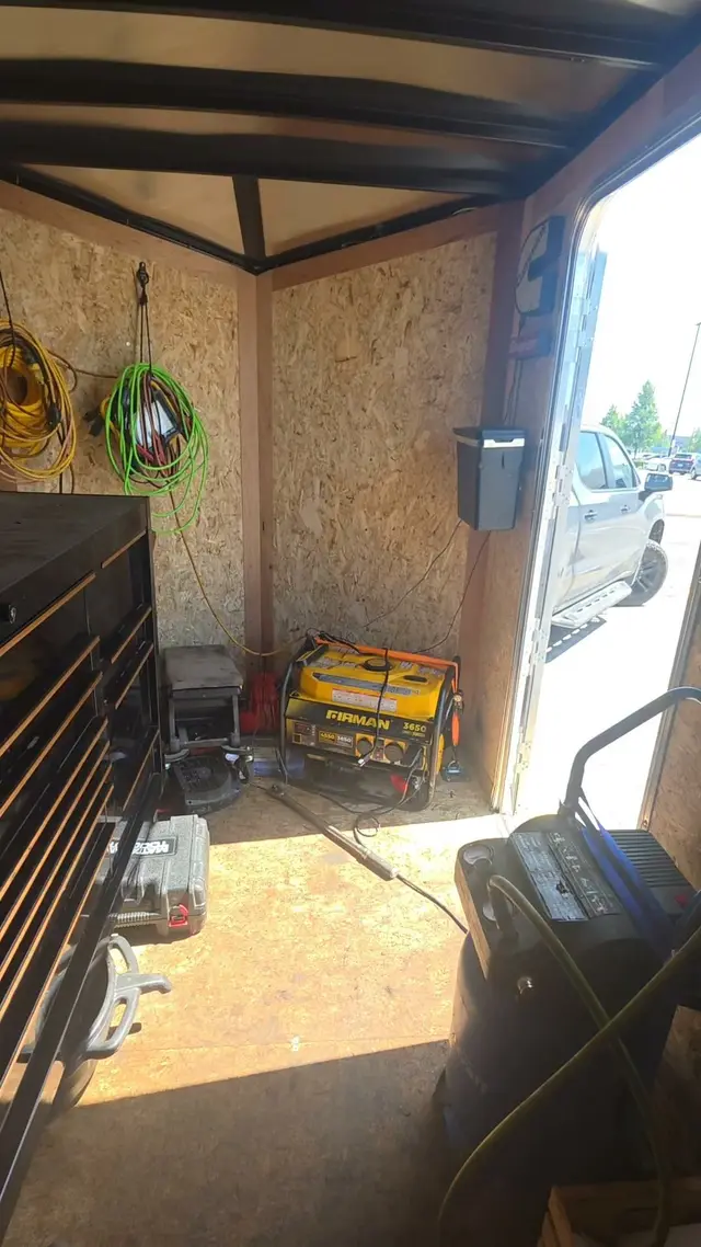 Inside Dusty's service trailer: a tool chest, air hoses, a generator and a compressor